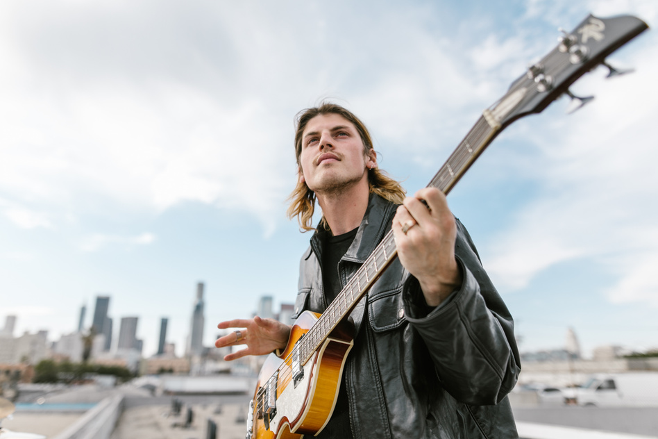 Man in Black Leather Jacket playing an Electric Guitar 